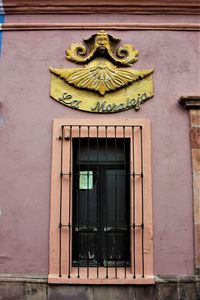 Low angle view of ornate window on building