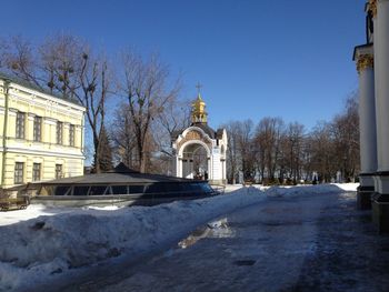 Snow covered building against clear sky