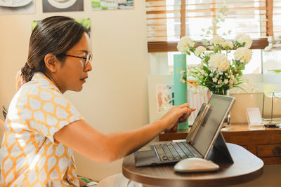 Young woman using laptop at home