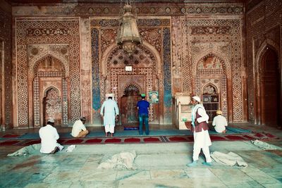 Rear view of people at temple outside building