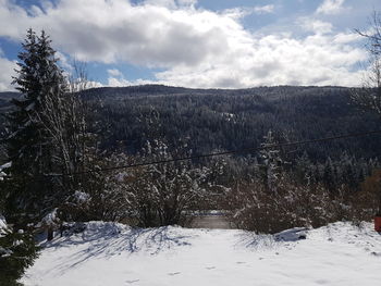 Scenic view of snow covered landscape against sky