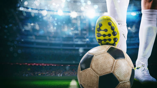 Low section of woman standing on soccer field