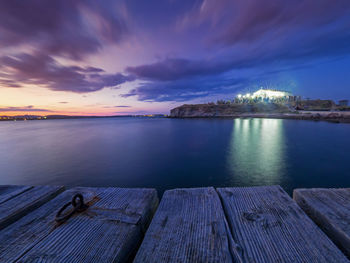 Pier over sea against sky during sunset