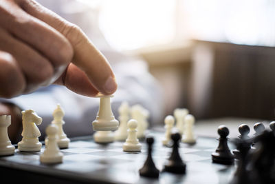 Close-up of hand playing chess