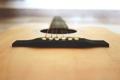 Close-up of guitar on table