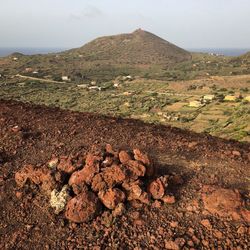 Aerial view of land and mountain against sky