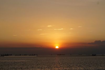 Scenic view of sea against orange sky