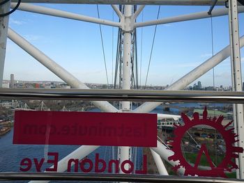 Information sign on bridge against sky