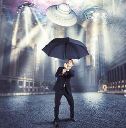 Full length of a young woman standing in rain