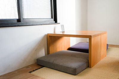 Wooden table by window at home