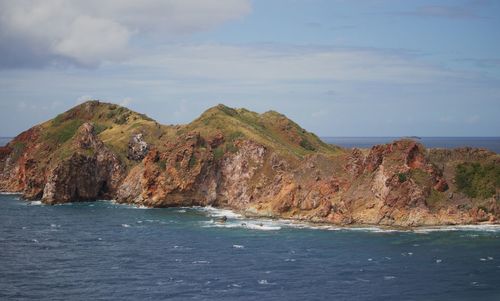 Scenic view of sea and mountains against sky