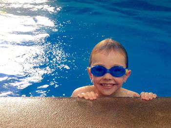 High angle portrait view of happy boy in swimming pool