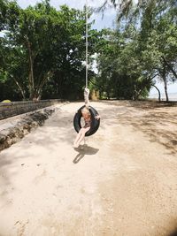 Man sitting on swing at playground