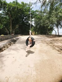 Girl sitting on swing at playground