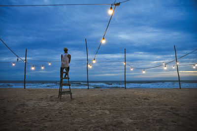 Man standing on beach against sky