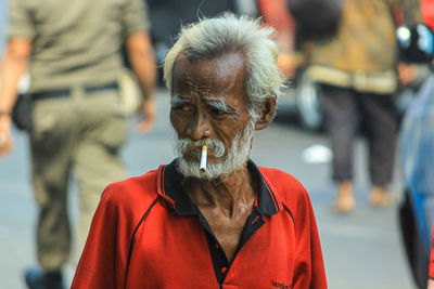 Portrait of man with umbrella on street