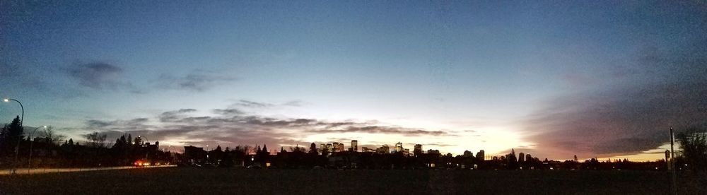 Silhouette of city against sky during sunset