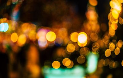 Defocused image of illuminated christmas lights at night