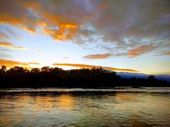 Scenic view of lake against sky during sunset