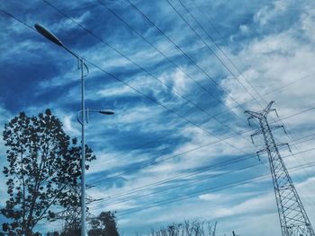 Low angle view of electricity pylon against sky