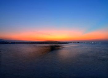 Scenic view of sea against clear sky during sunset