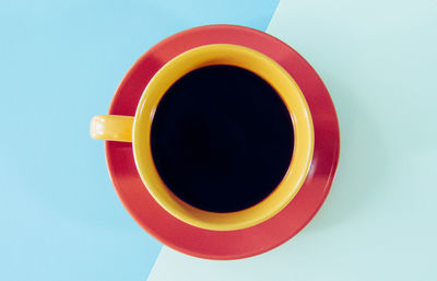 Directly above shot of coffee cup against blue background