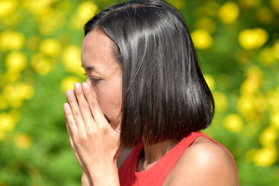 Close-up woman covering mouth