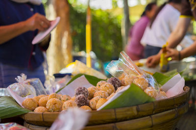 Midsection of man with vegetables on table at market stall