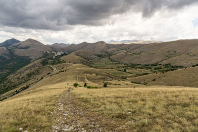 Scenic view of landscape and mountains against sky