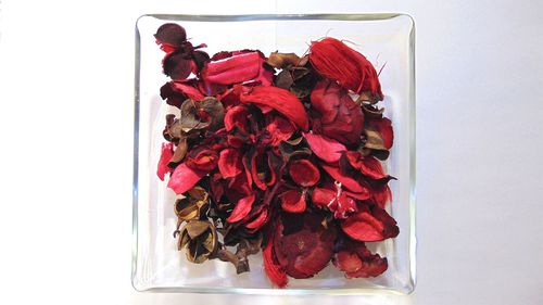 Close-up of red fruit over white background