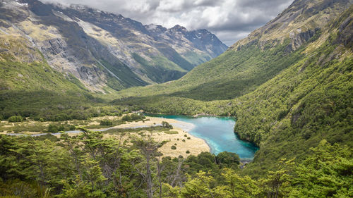 Scenic view of lake and mountains against sky