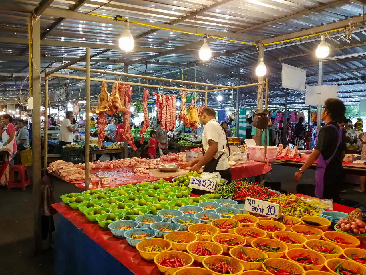 PEOPLE AT MARKET STALL AT NIGHT