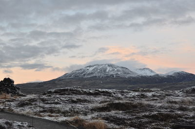 Scenic view of snowcapped mountains against sky during sunset