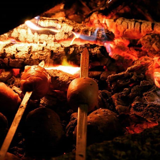 indoors, close-up, glowing, illuminated, flame, burning, night, no people, fire - natural phenomenon, heat - temperature, lighting equipment, still life, religion, focus on foreground, decoration, abundance, large group of objects, low angle view, wood - material, selective focus