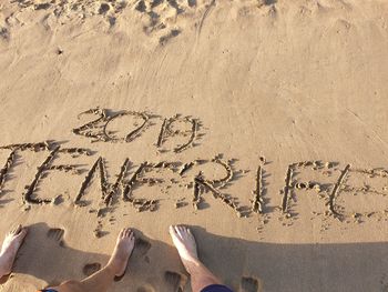 High angle view of text on sand at beach