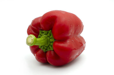 Close-up of red bell peppers against white background