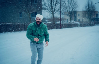 Portrait of man standing on snow