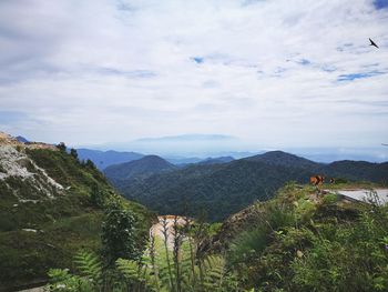 People standing on mountain against sky