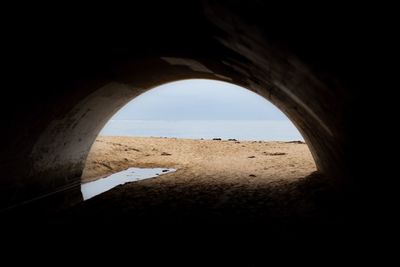 Scenic view of sea against clear sky seen through archway