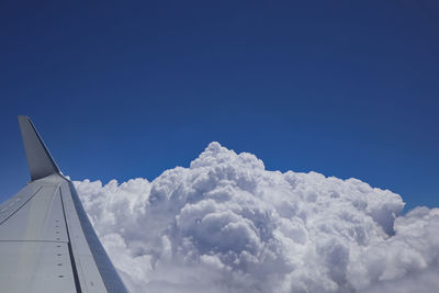 Low angle view of airplane flying against sky