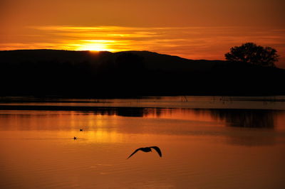 Scenic view of lake against sky during sunset