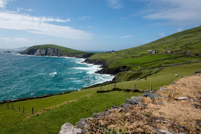 Scenic view of sea and mountains against sky