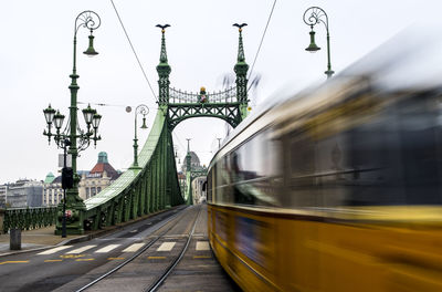 Blurred motion of tramway on liberty bridge in city