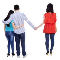 Rear view of friends standing against white background