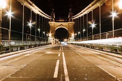 Light trails on bridge in city at night