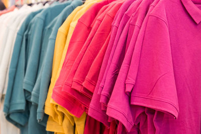 Close-up of multi colored clothes hanging in store
