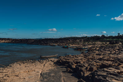 Scenic view of beach against blue sky
