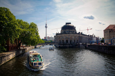 Boats moored at river in city