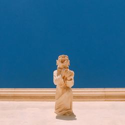 Statue in museum against clear blue sky