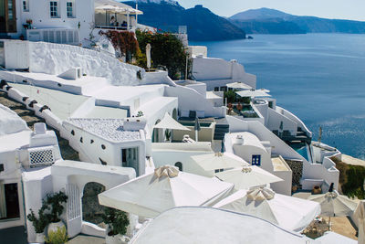 High angle view of buildings by sea against sky